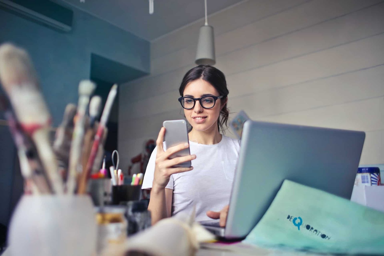 A young woman smiling at her new responsive website on her mobile phone