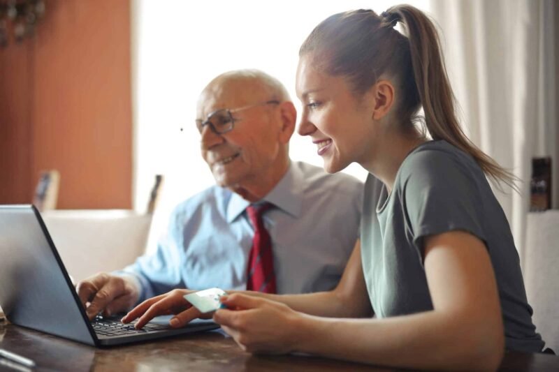 A young woman and her dad admiring their new website