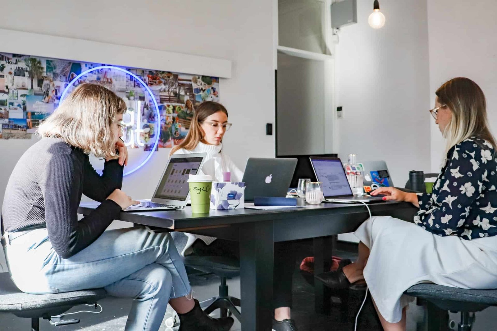 Three female web designers collaborating on web hosting