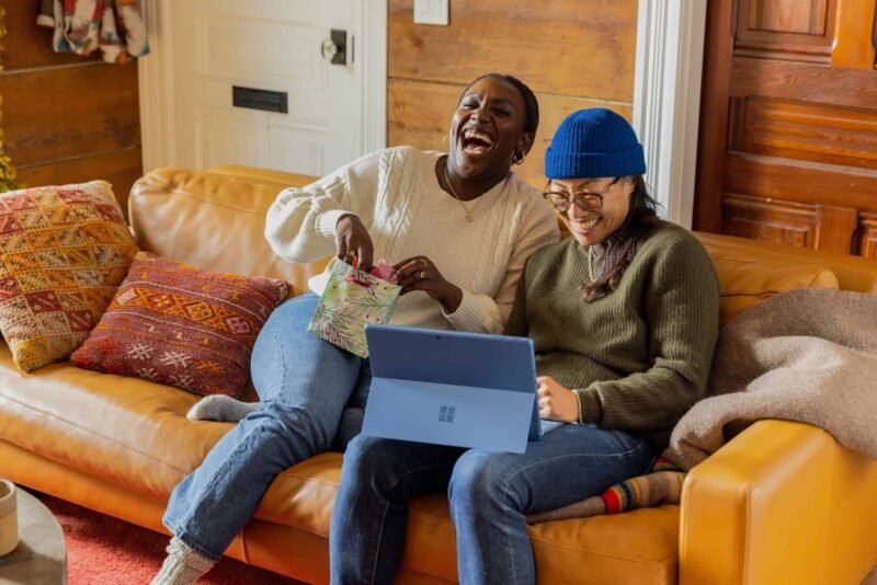 A black woman and Asian woman being excited about their new website