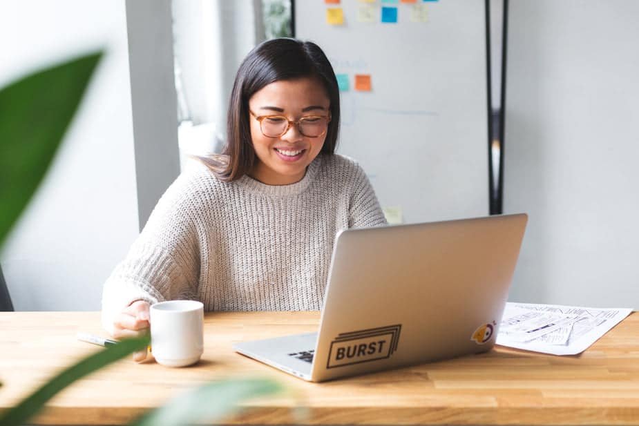 Asian web designer on her laptop