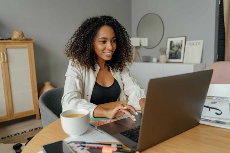 An African-American woman reading a business blog